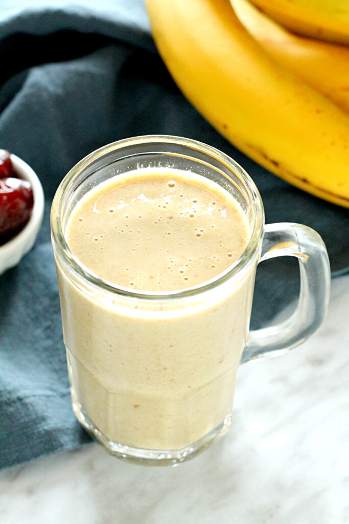 Banana Date Almond Protein Smoothie in a glass mug.