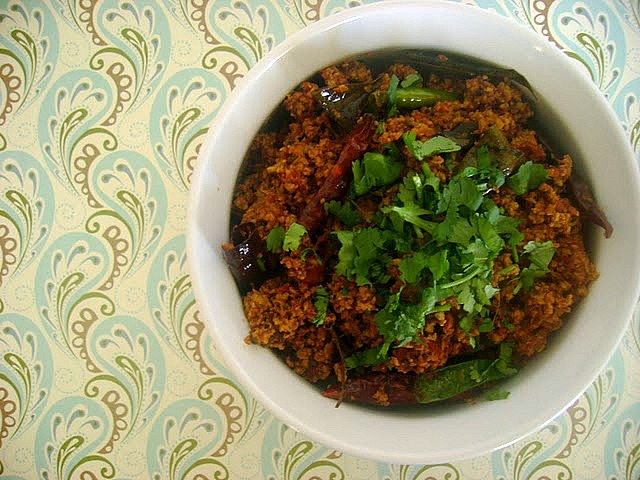 Achaar Ka Kheema in a white dish garnished with cilantro.